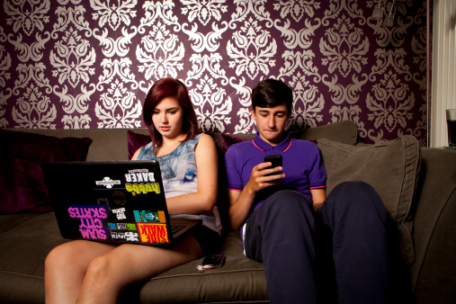 Young people using computers and mobile devices for social networking